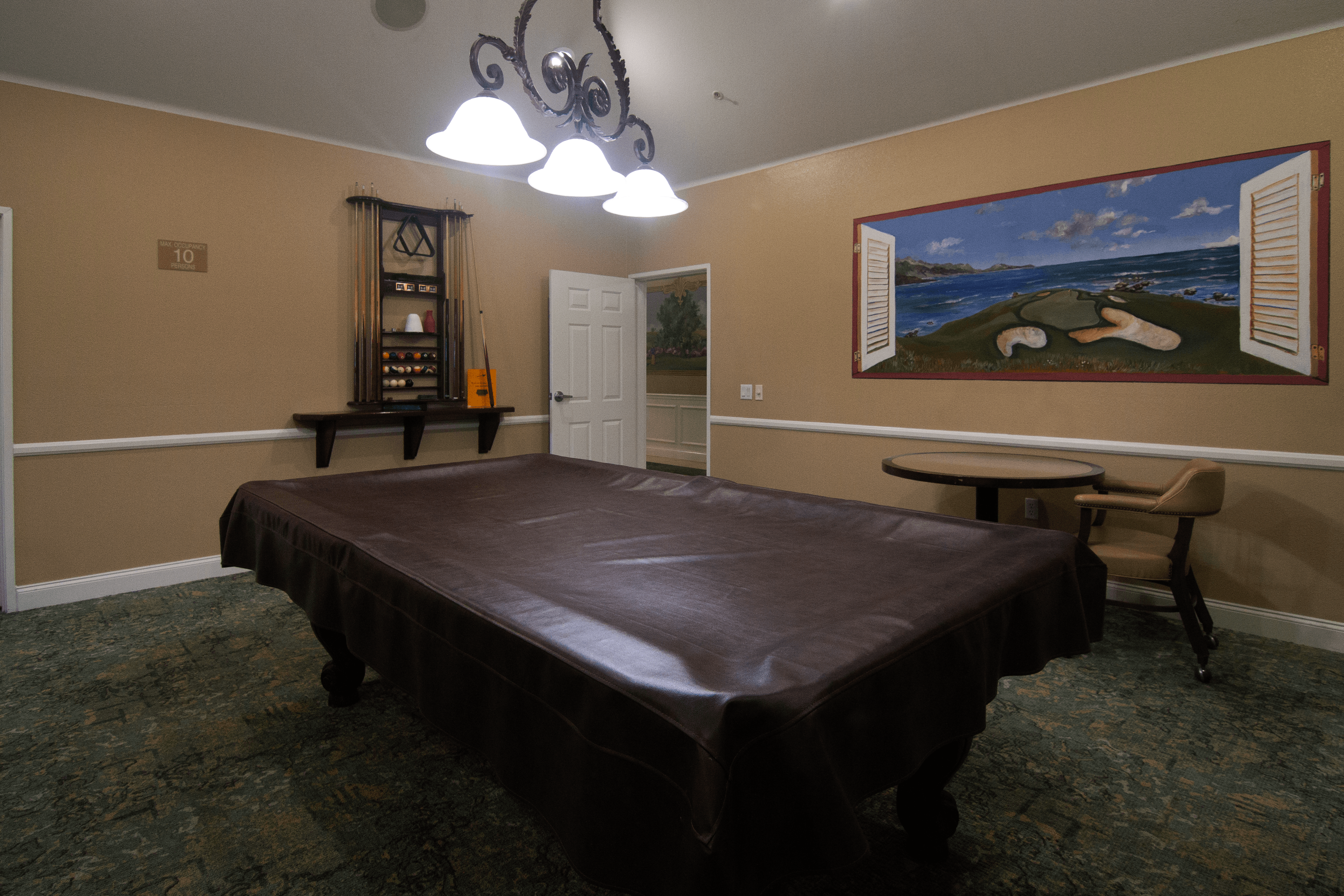 A room with a bed, a chair, and a painting on the wall.,A room with a bed, a chair, and a painting on the wall.