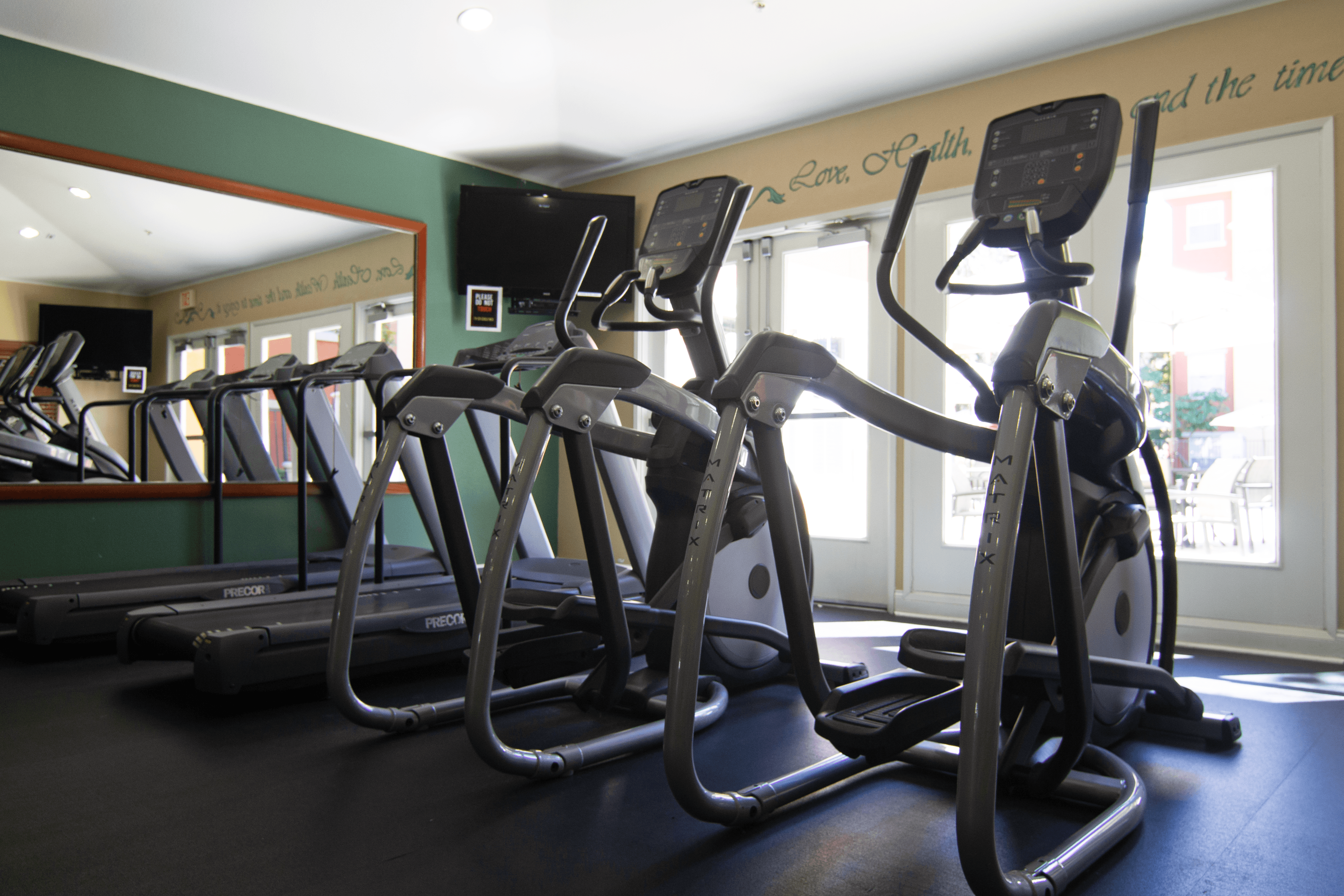 A gym with treadmills and exercise bikes.,A gym with treadmills and exercise bikes.