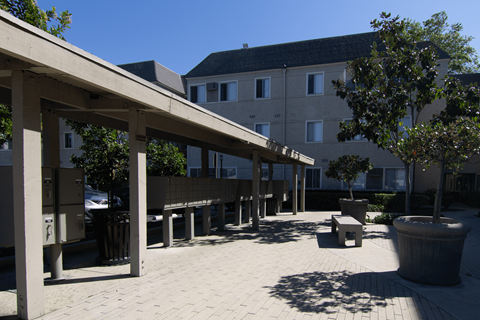 A sunny day at the outdoor seating area of a building.