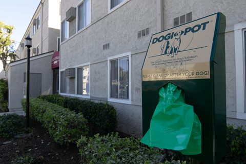A sign for DoggiePot Law is displayed in front of a building.