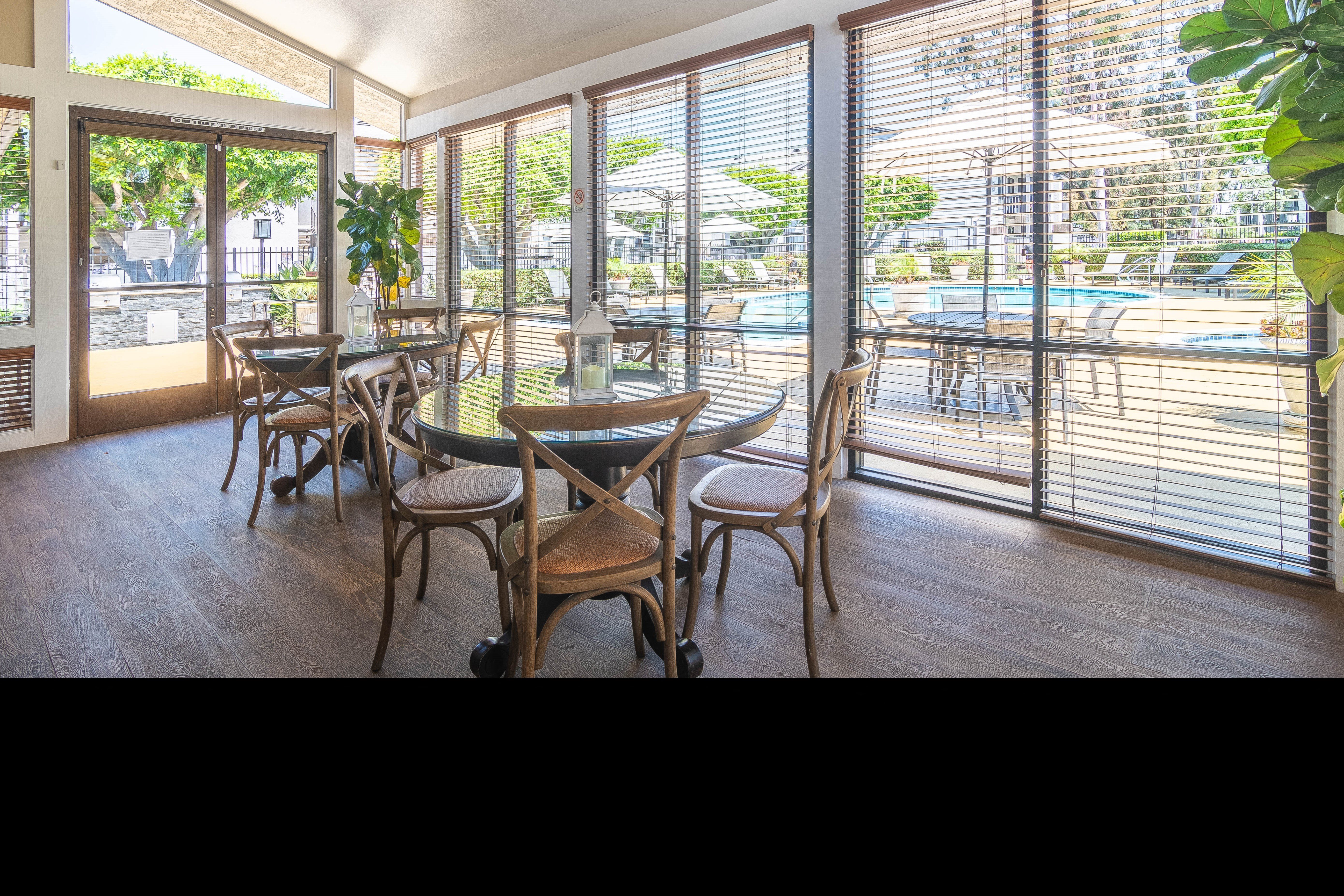 a dining room with a table and chairs and a pool