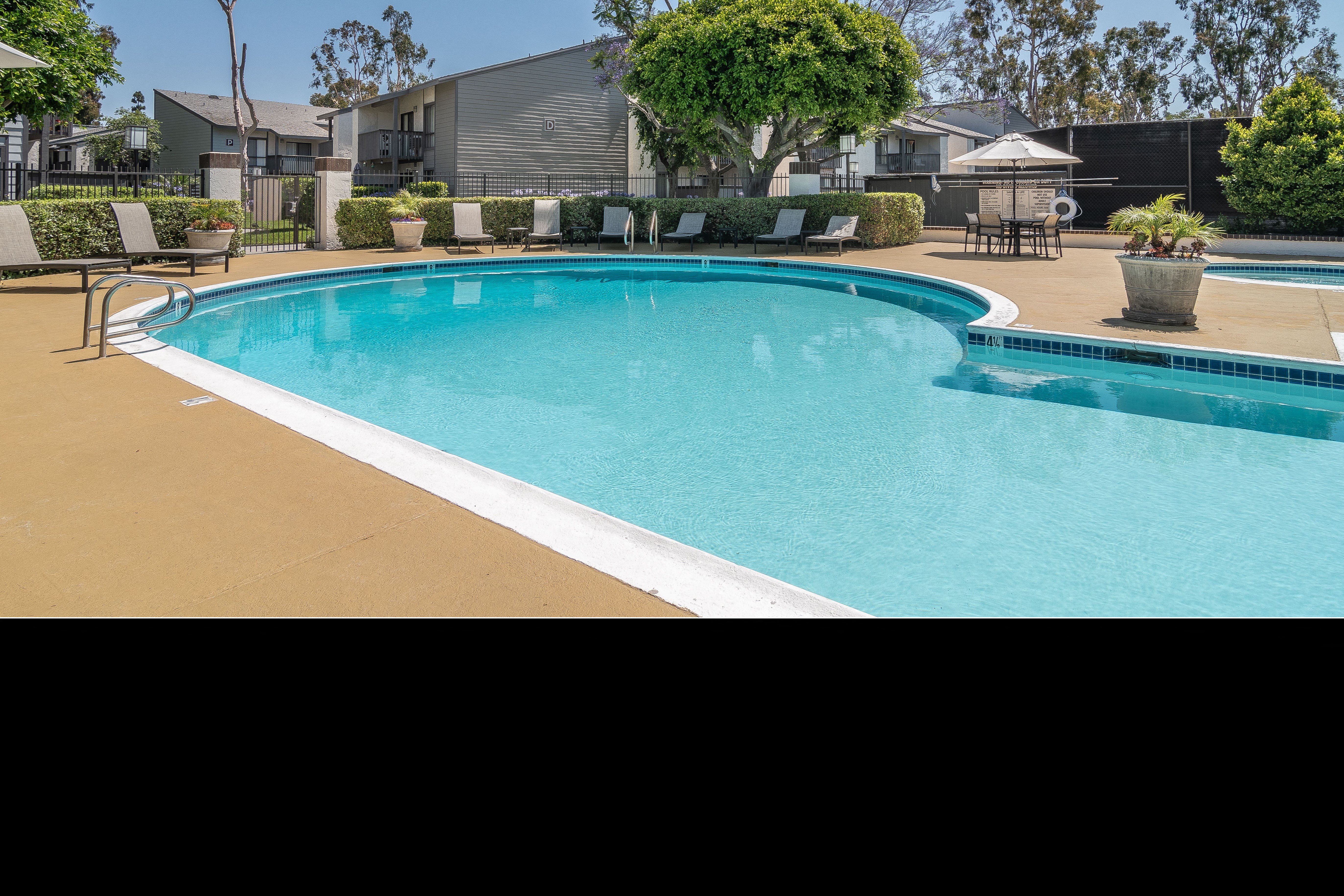 a large swimming pool with chairs around it