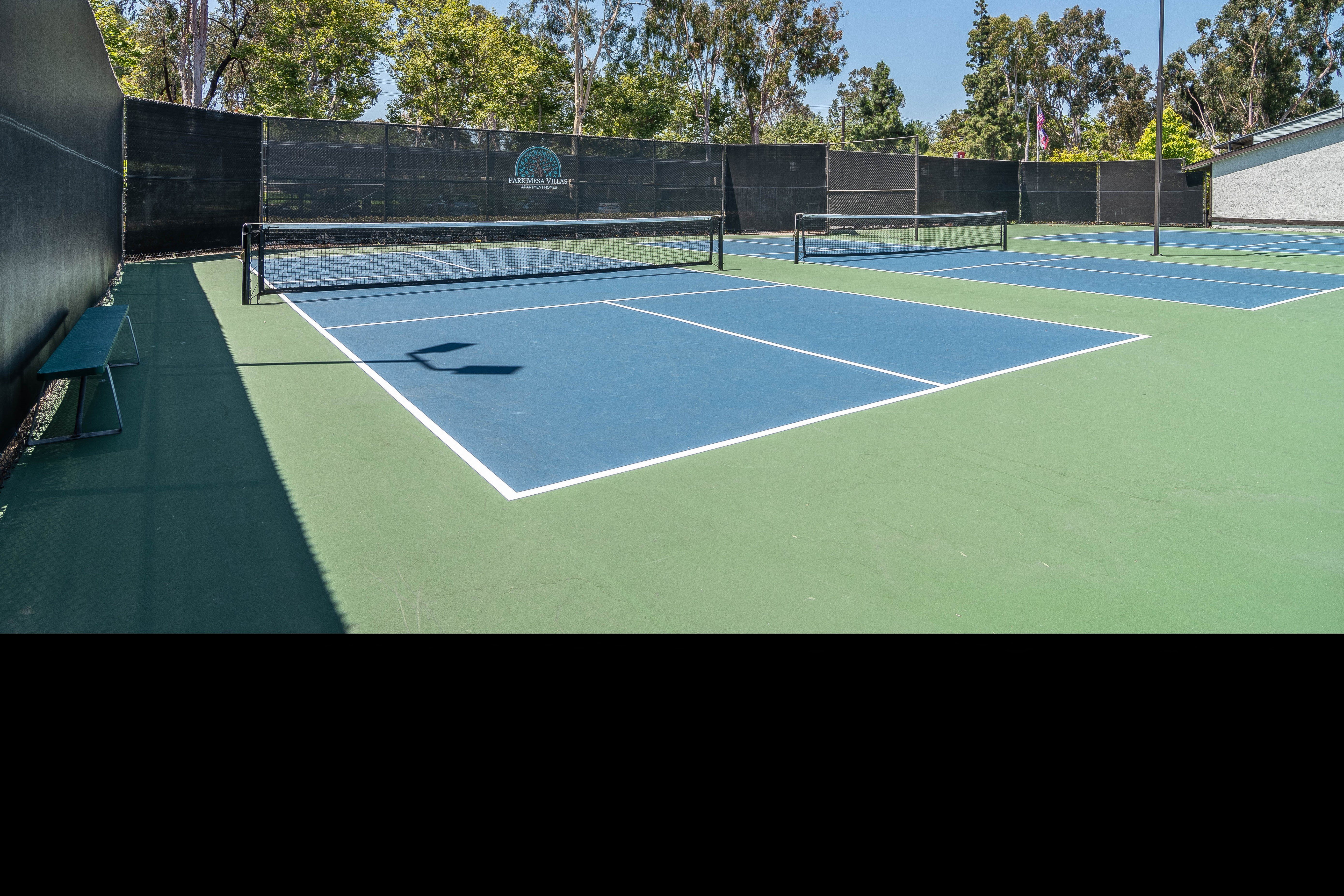 a tennis court with two nets on a blue and green court