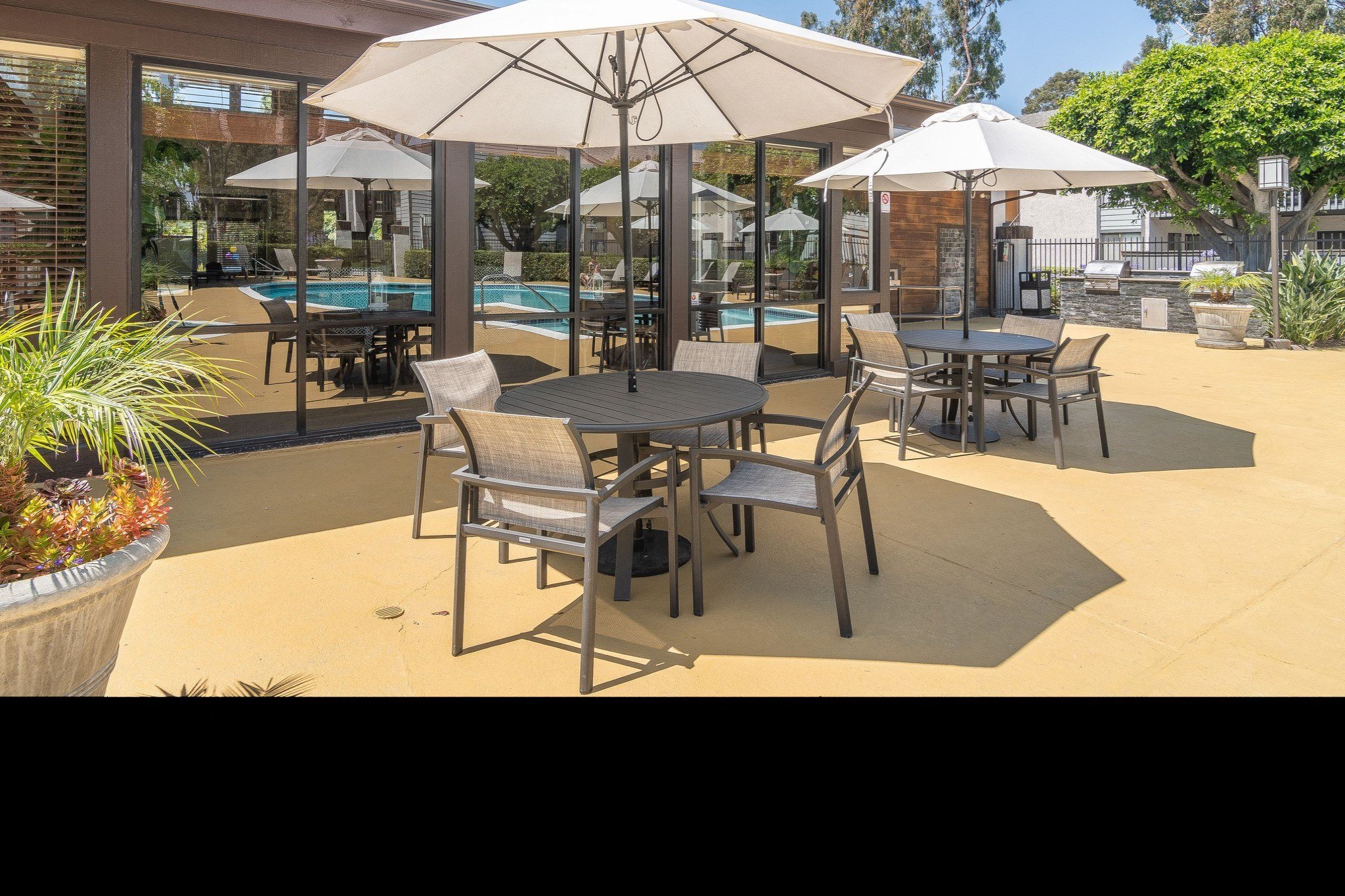 a group of tables with umbrellas on a patio