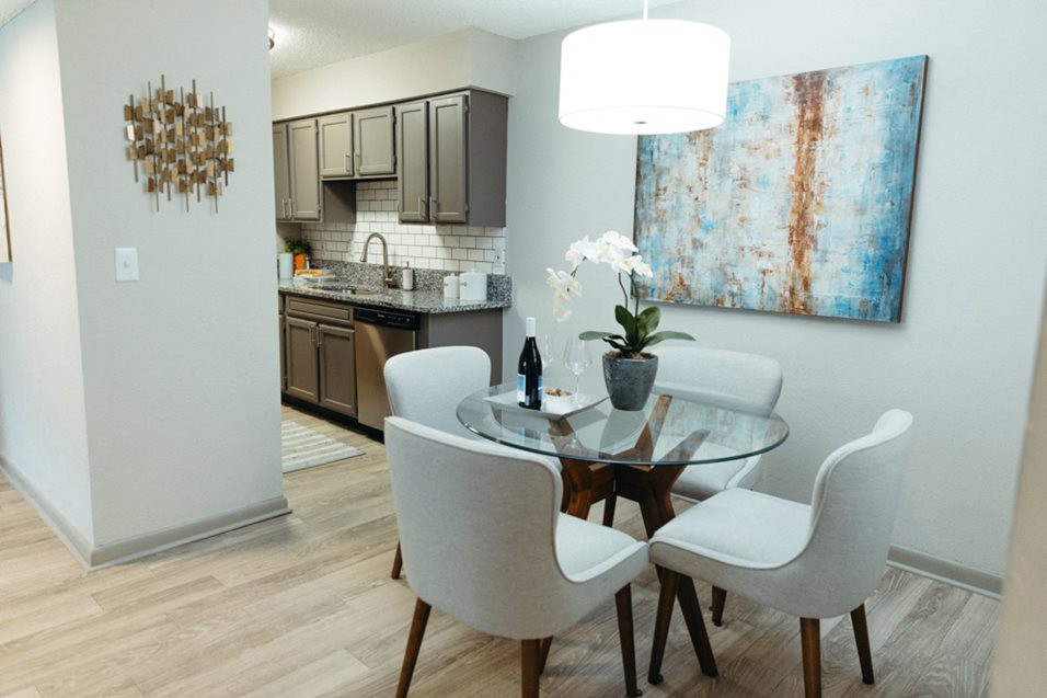 a dining room with a table and chairs and a kitchen