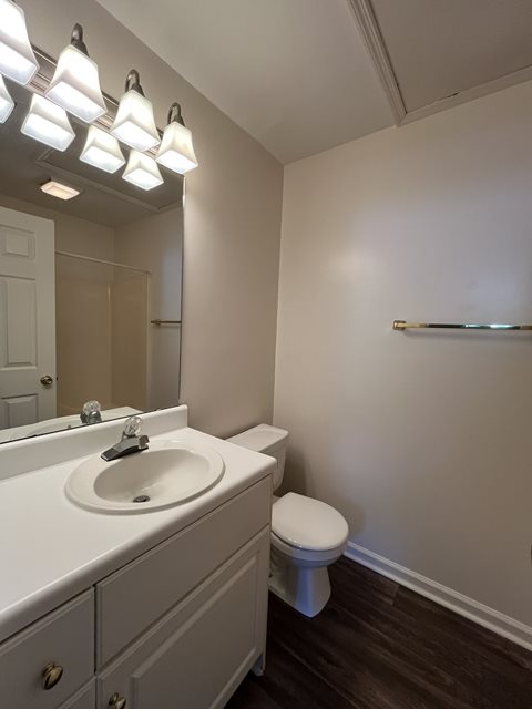 A white bathroom with a toilet and sink.