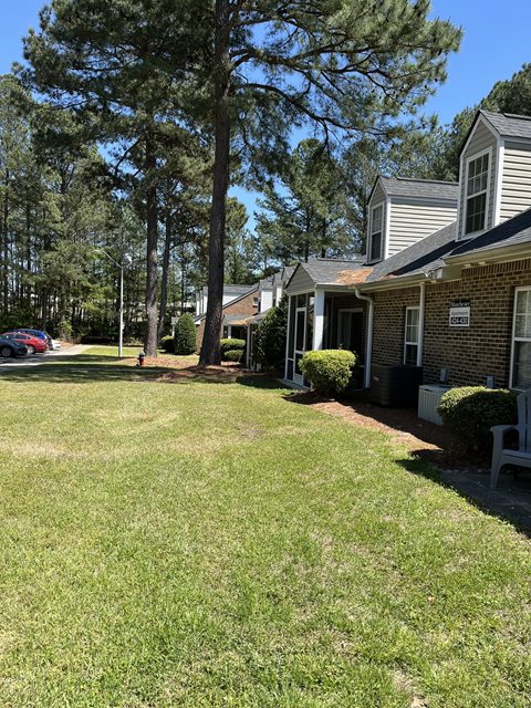A residential area with houses and green grass.