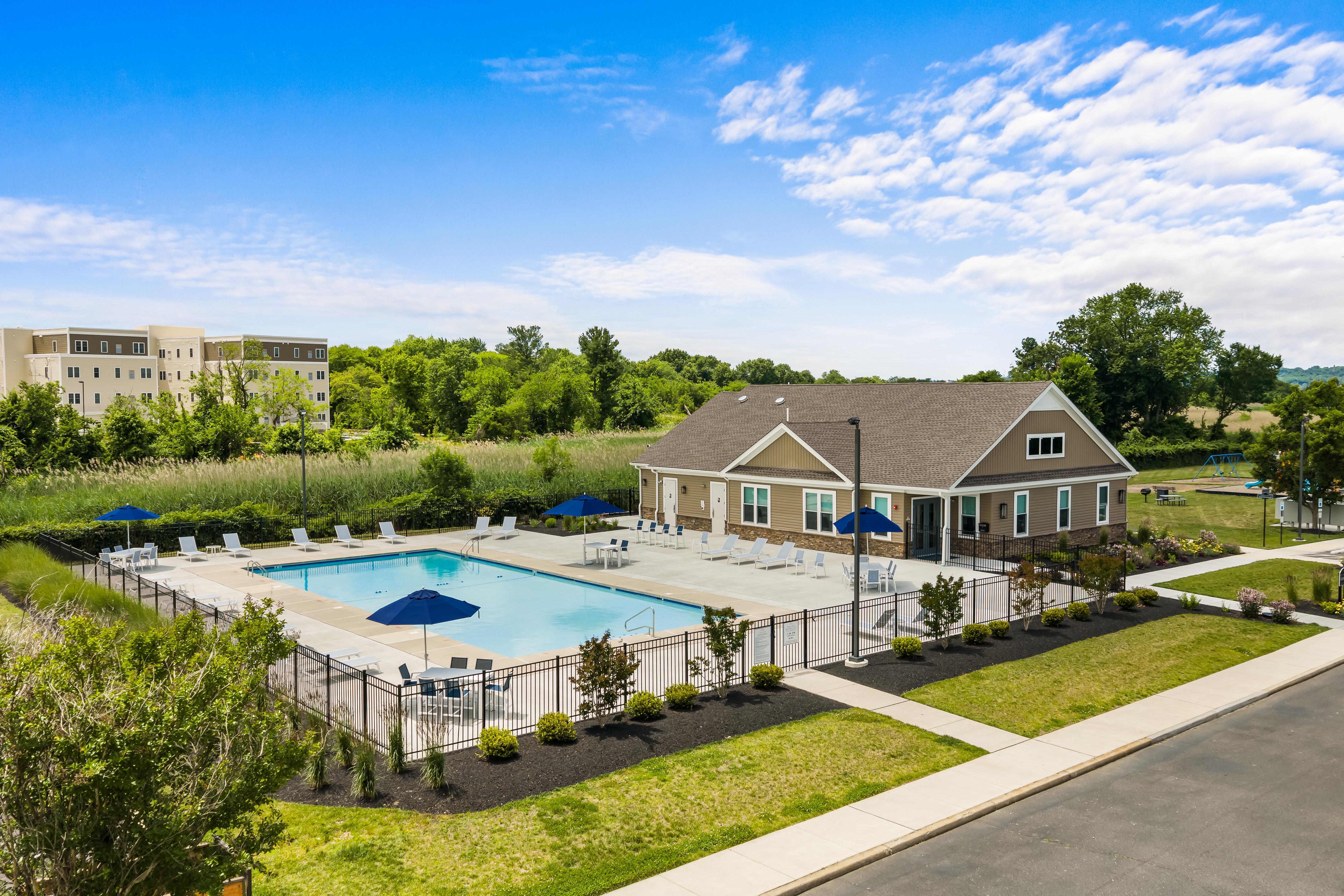 A large house with a pool in front of it.