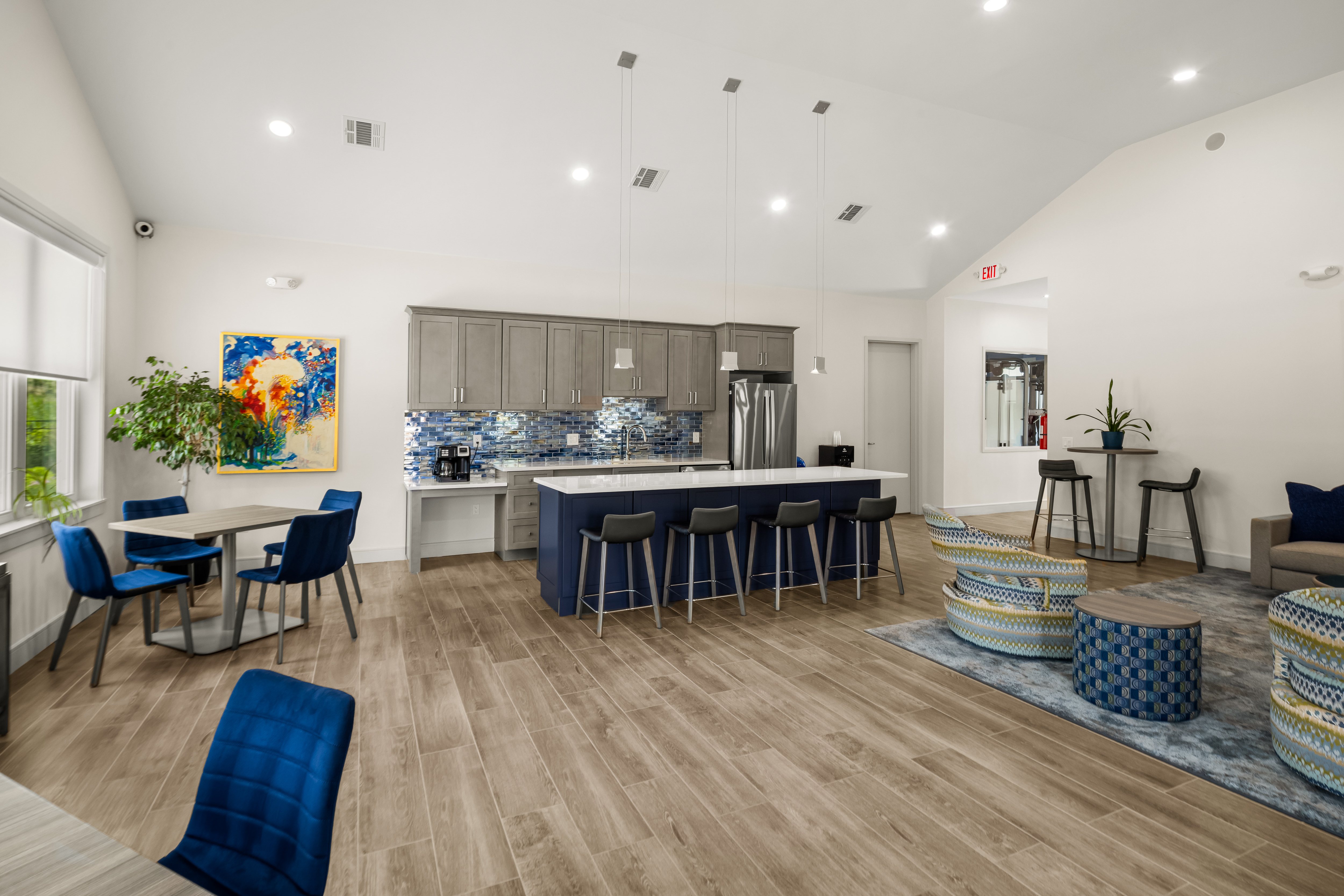 A modern kitchen with a dining table and chairs.