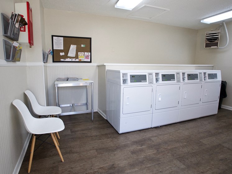 Laundry facilities at Countryside Villa with washer, dryers, folding table, and chairs