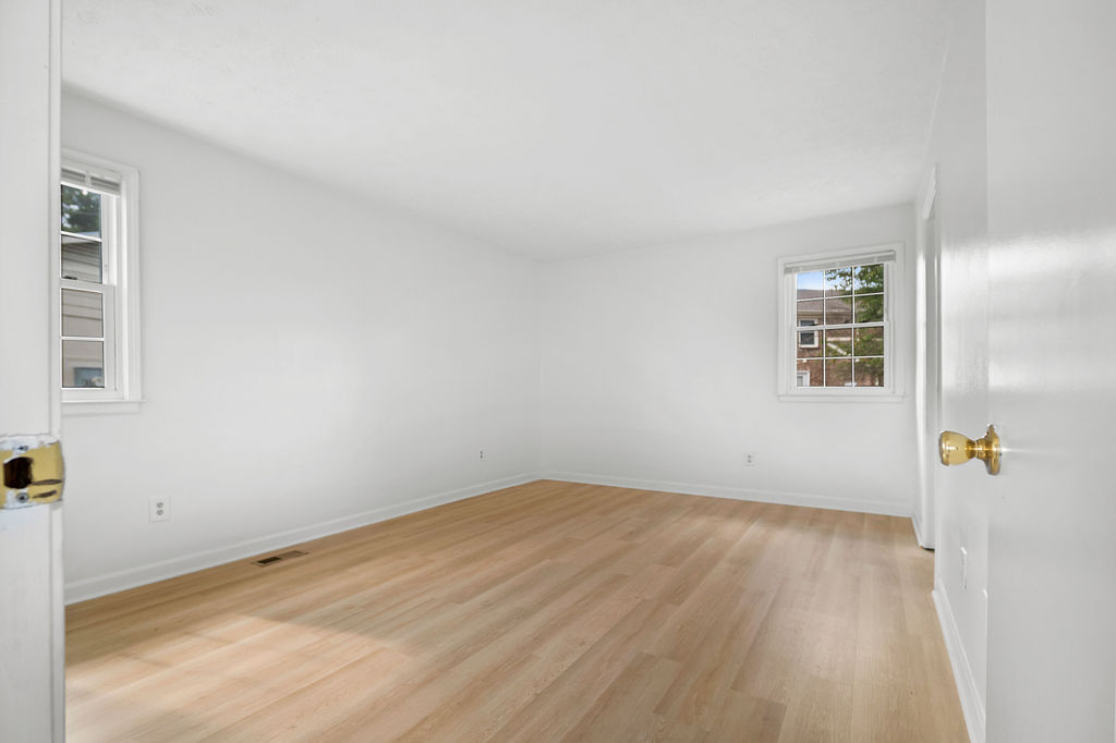 A room with a wooden floor and white walls.