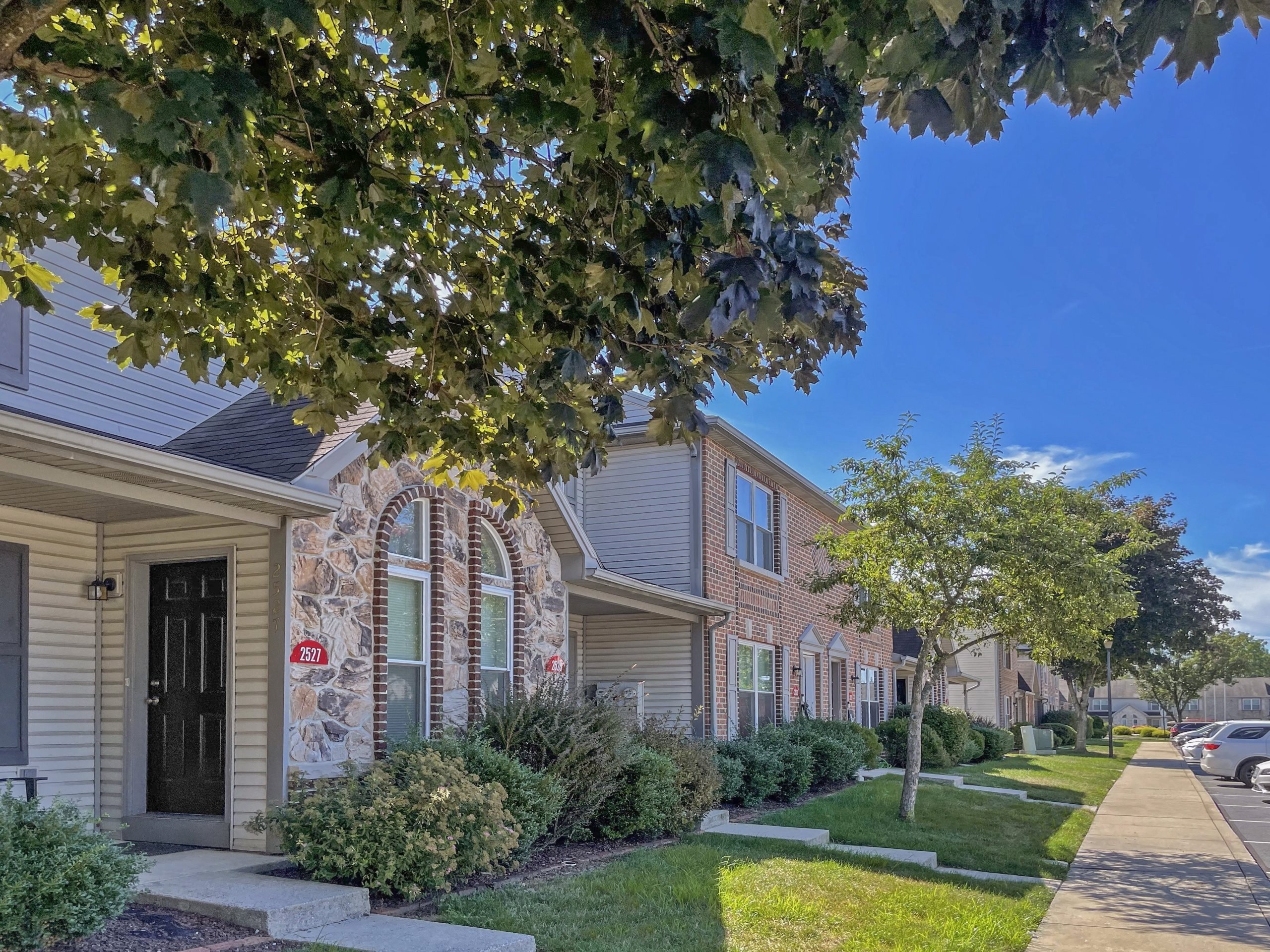 A row of houses with a clear blue sky above them.