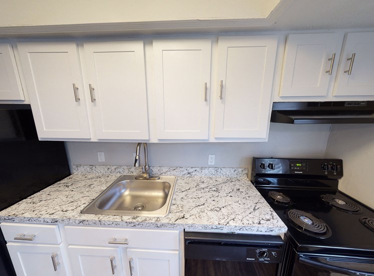 Kitchen with sink, oven and countertops at Highland Village, Kansas City, 64129