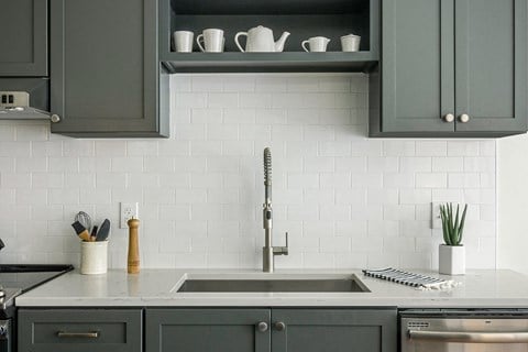 Modern kitchen with Moen faucet and shaker cabinets