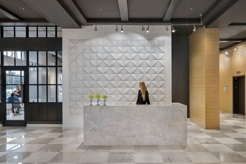 Marble desk with receptionist in Quarter lobby