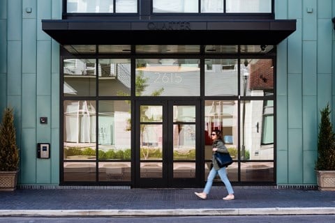 Front entrance of Quarter Phase 2 with woman walking in front of door