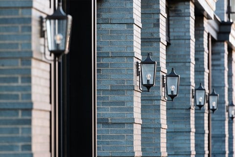 Gas-style lamps on exterior of Quarter Phase 2 Apartment building