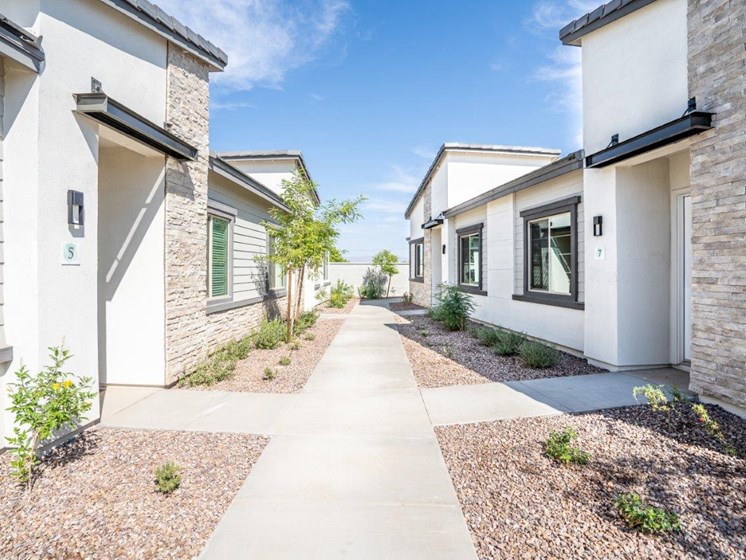 Landscaped walkways between the apartment homes at Village Greens of Queen Creek