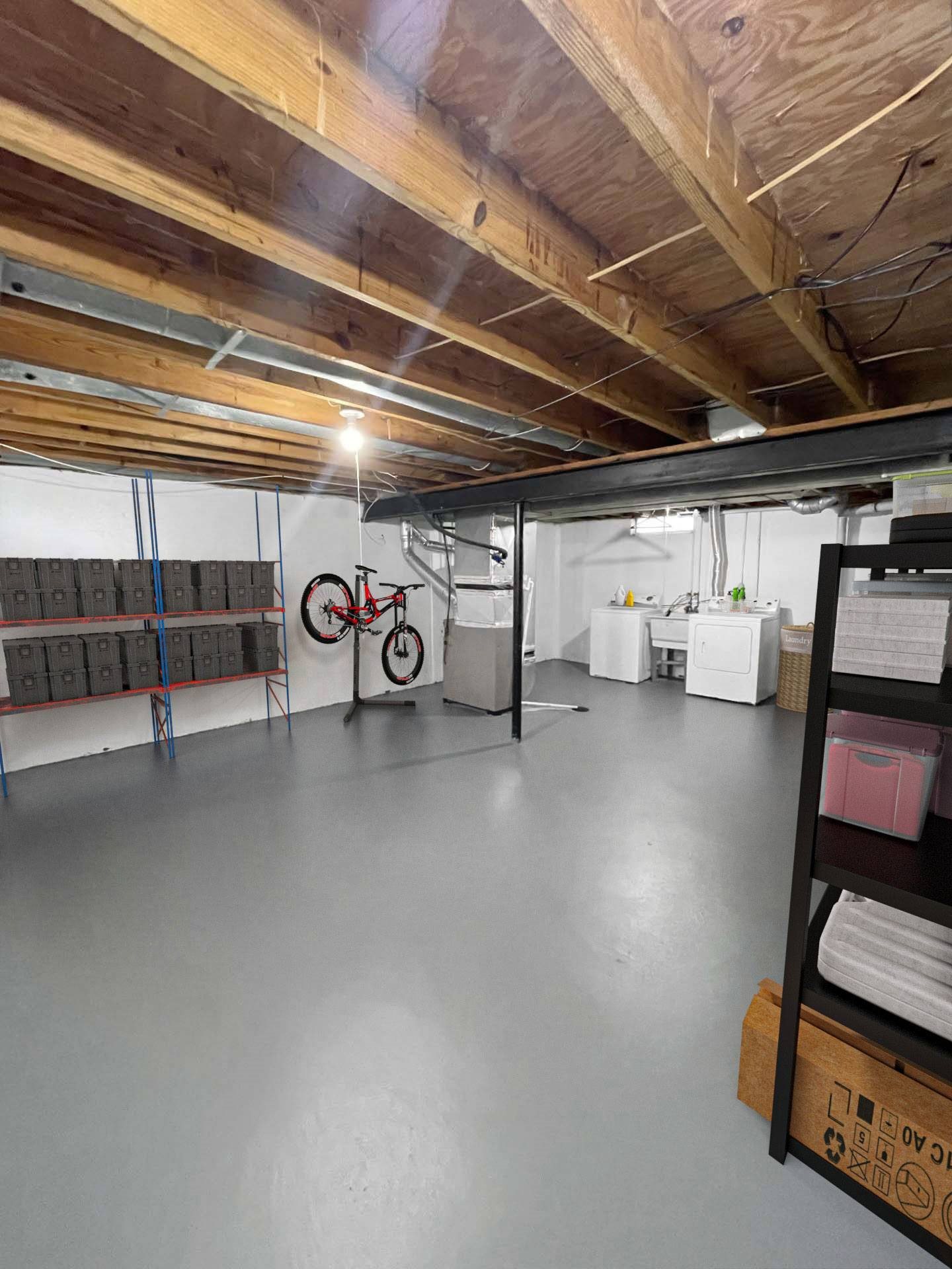 A spacious garage with a bicycle and storage shelves.