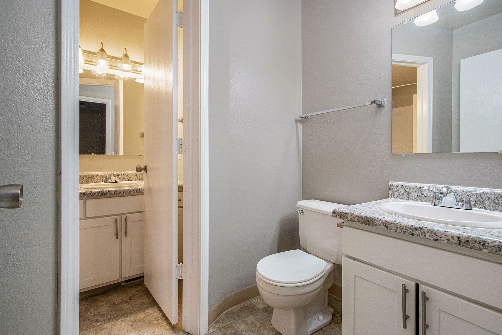 a bathroom with a toilet and a sink and a mirror