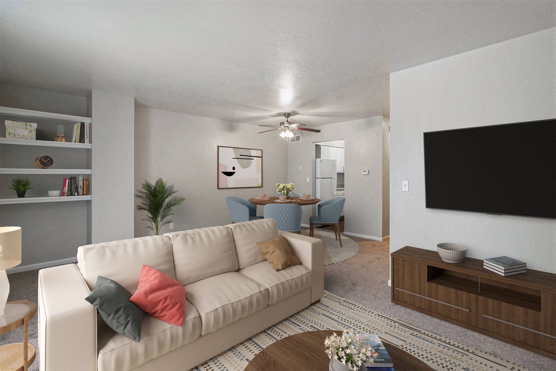 a living room with a white couch and a ceiling fan