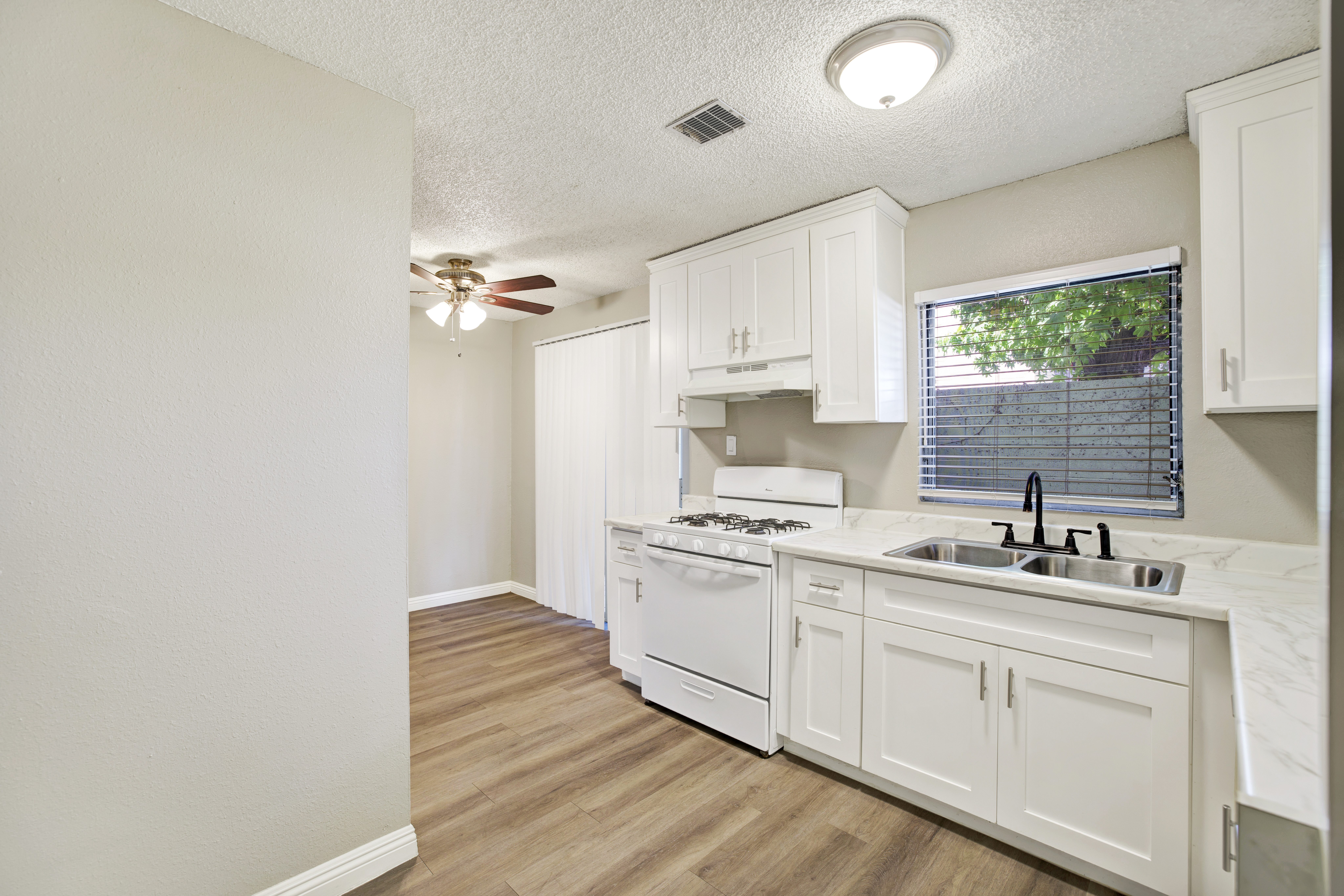 A white kitchen with a washer and dryer built in.