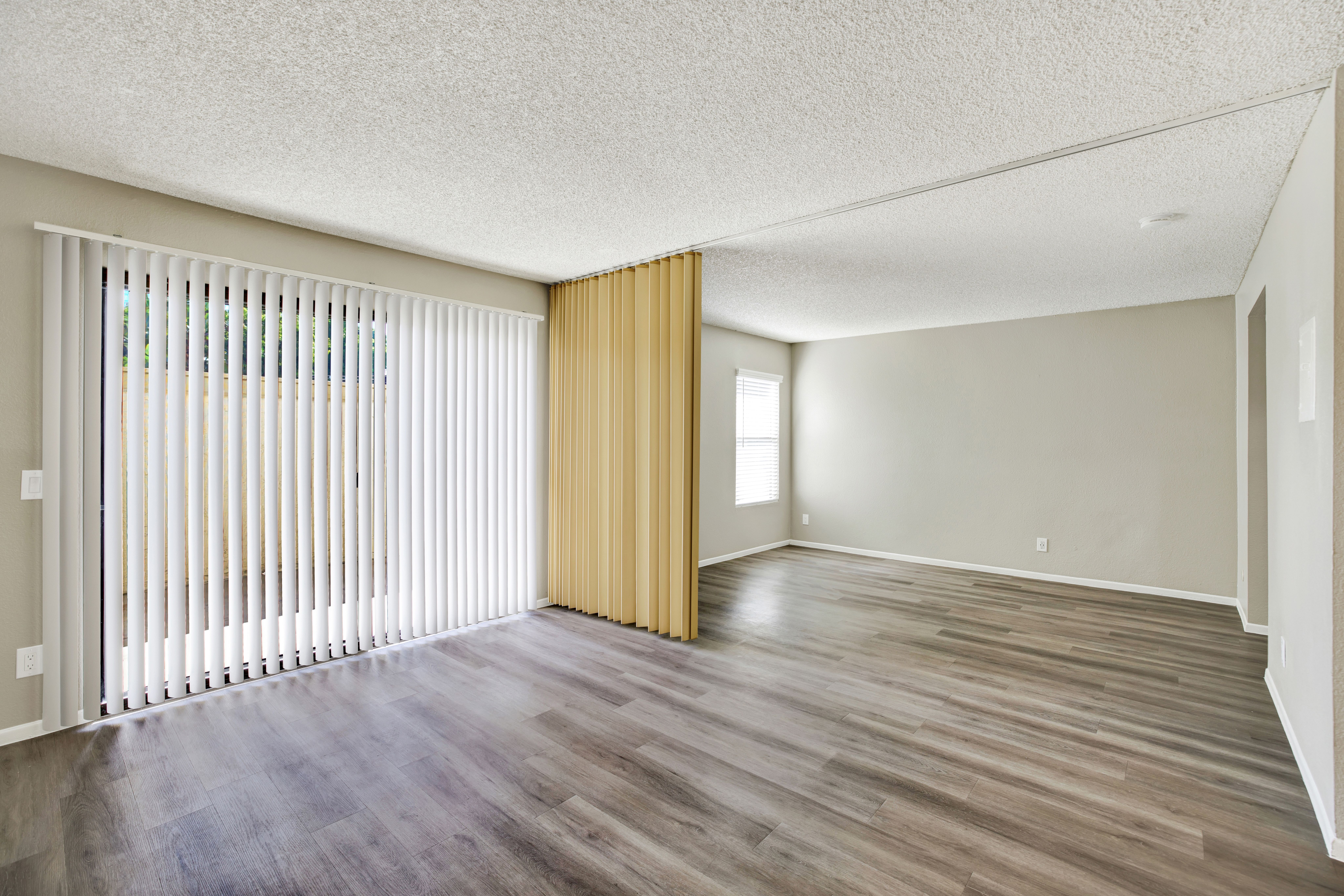 A room with wooden floors and a sliding door.