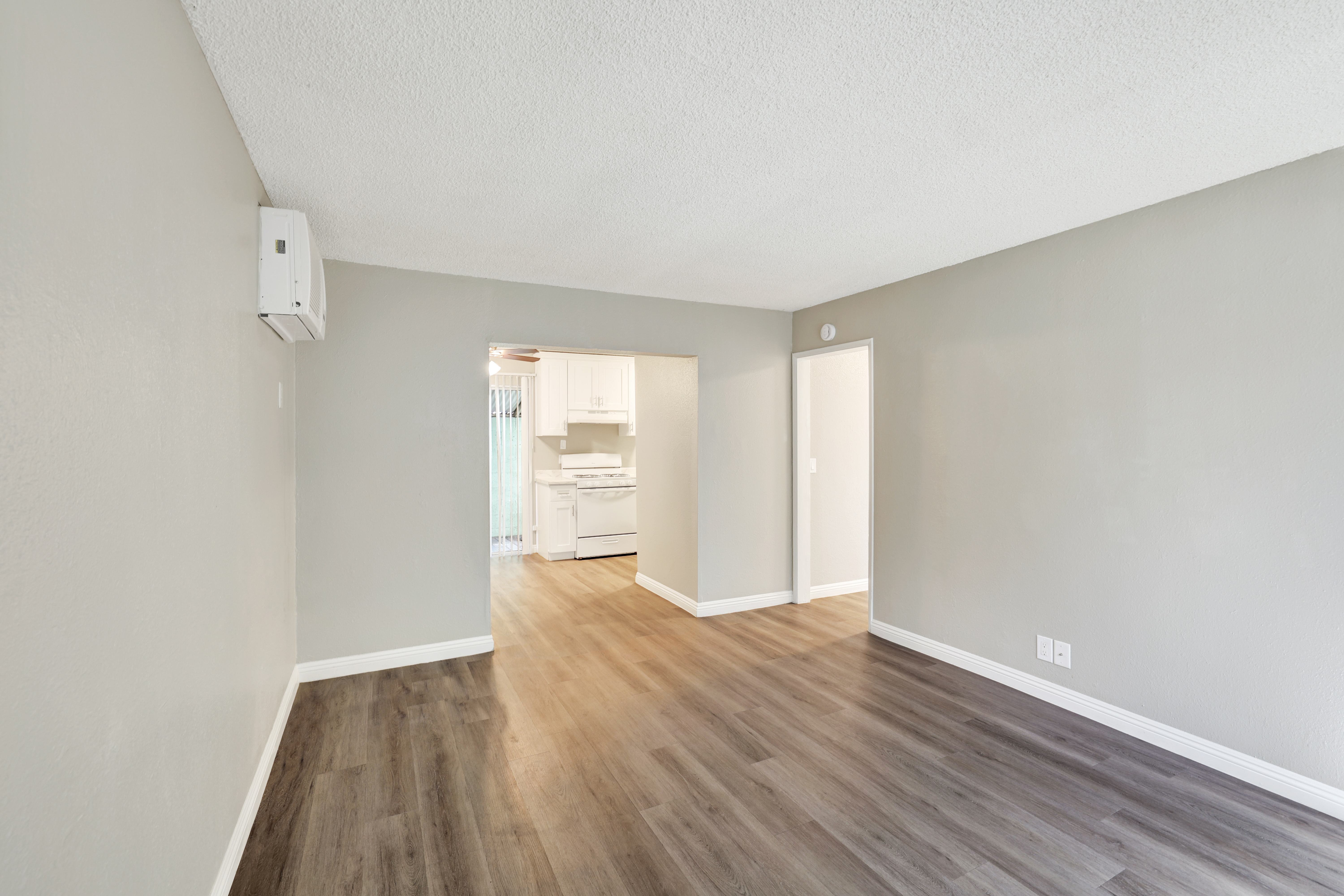 A room with wooden floors and white walls.
