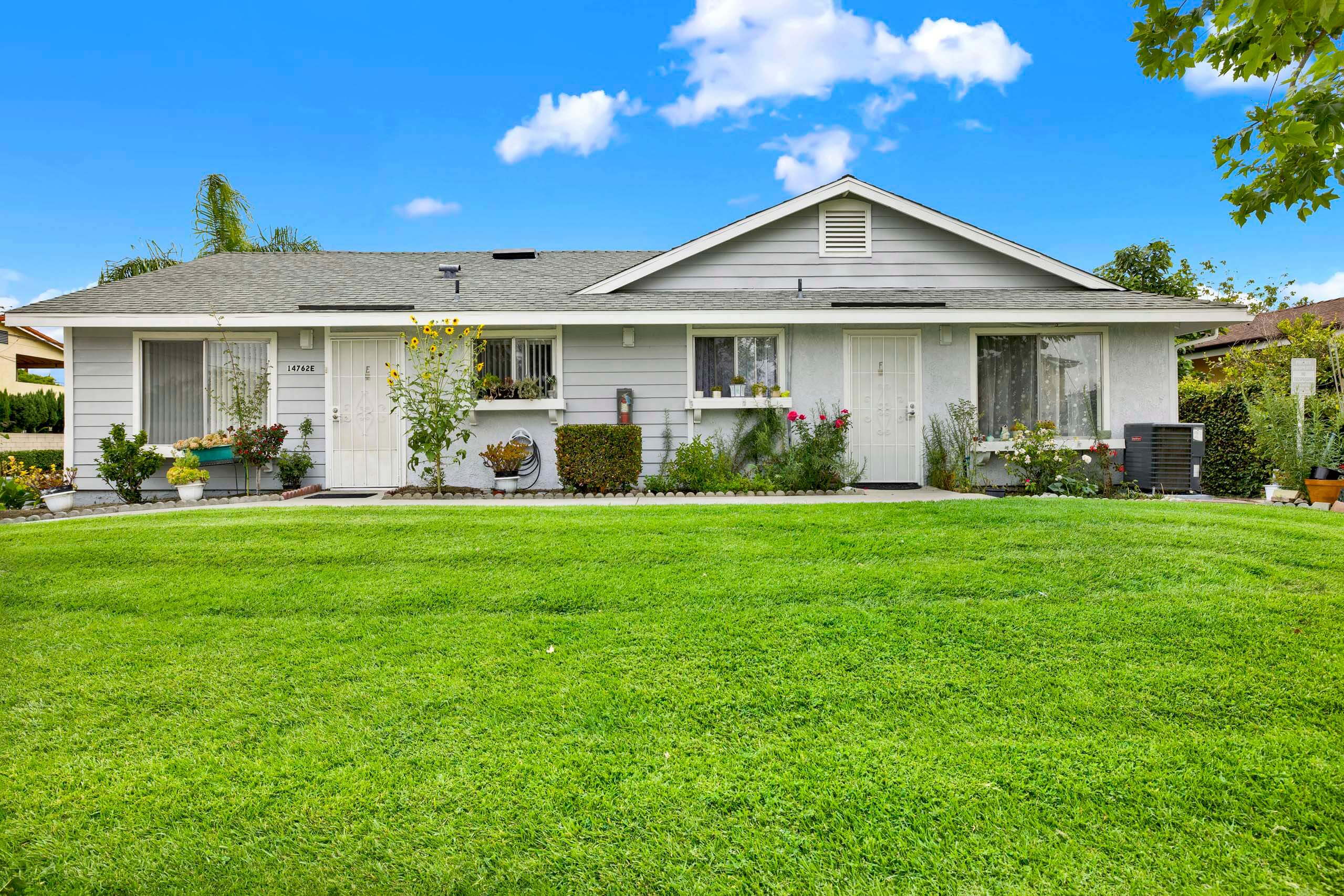 A house with a well-kept lawn in front.
