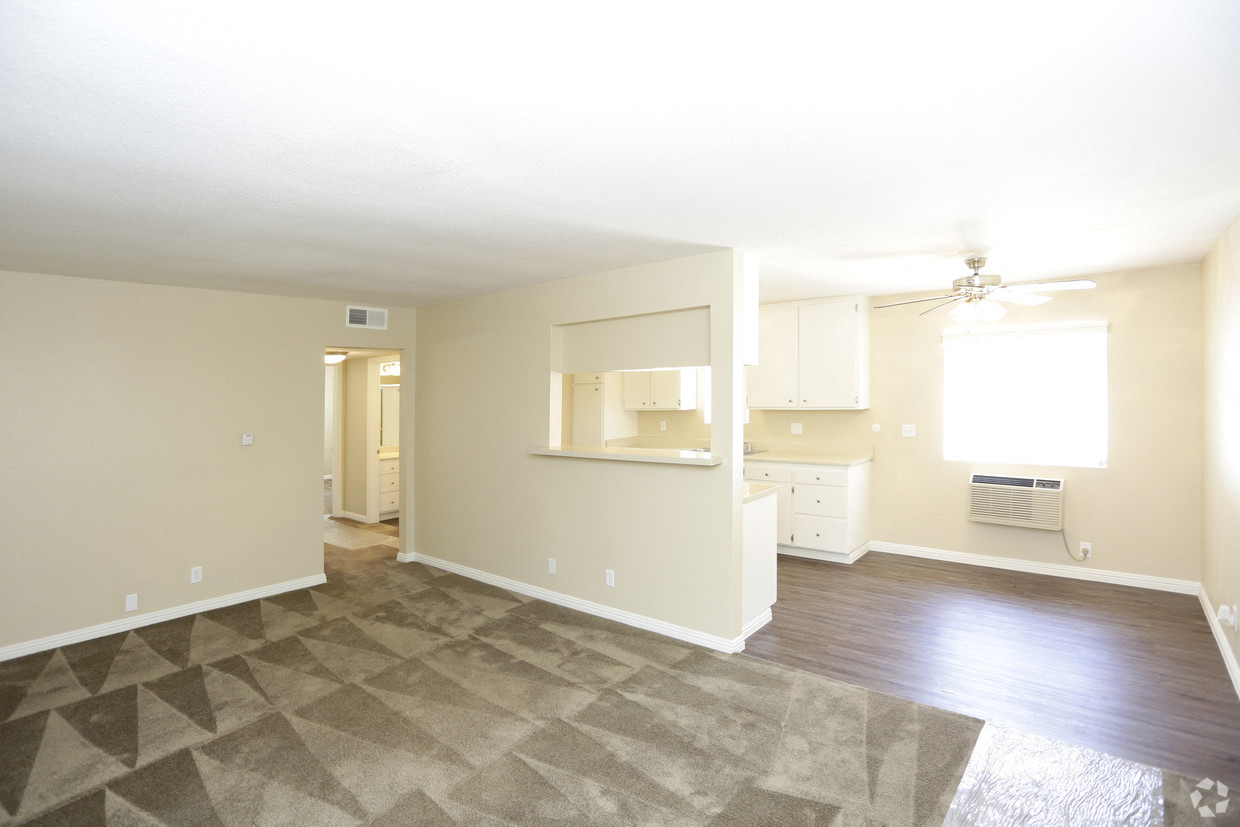 A spacious room with a ceiling fan and a window.