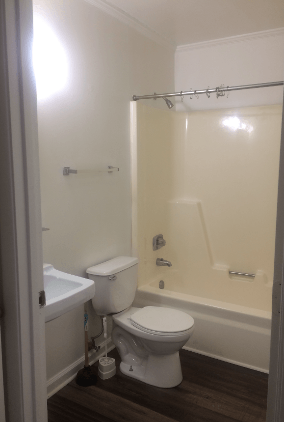 a small bathroom with a toilet and a tub
