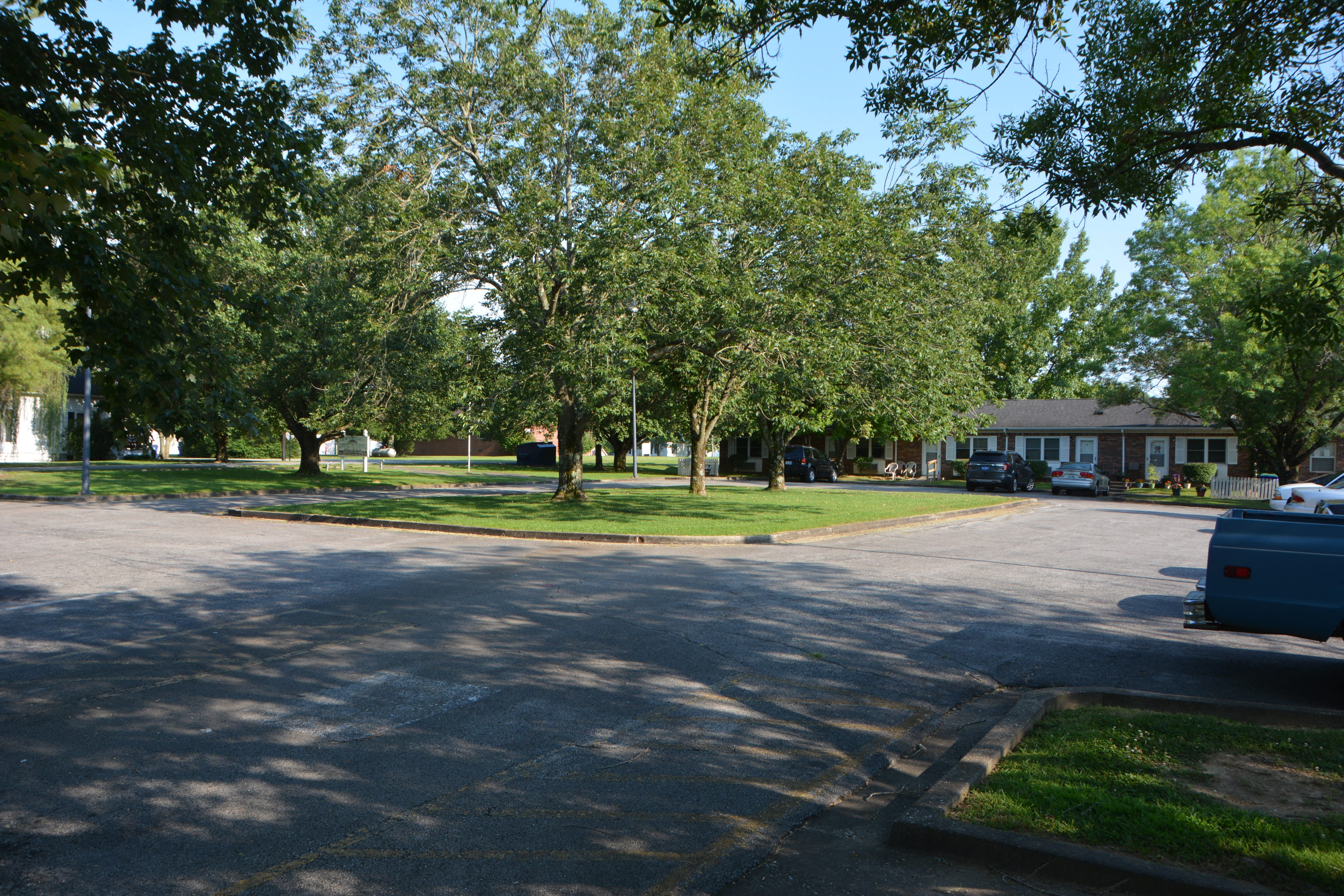 a street in a neighborhood with trees and houses