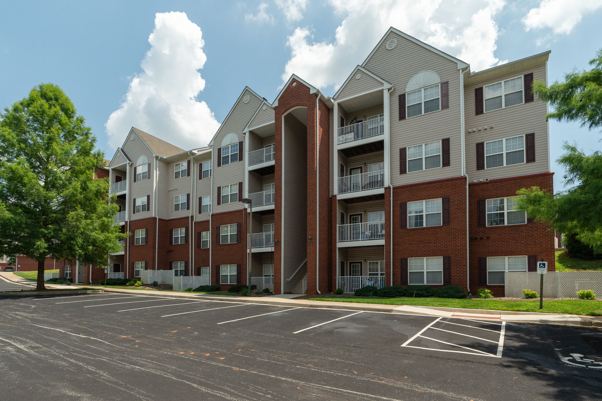 an empty parking lot in front of an apartment building