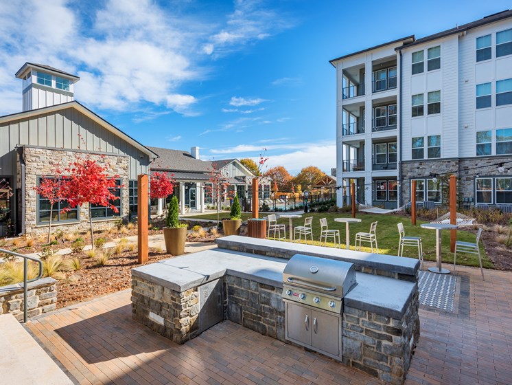 Outdoor apartment community space with grilling stations at Bon Haven in Spartanburg, SC