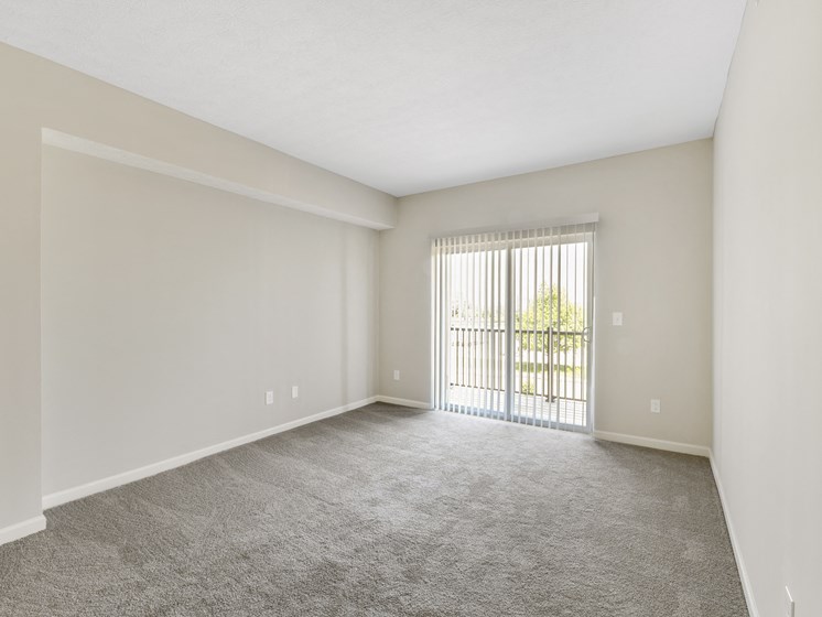 Living Room with Door Access to Balcony at Austin Place Apartments