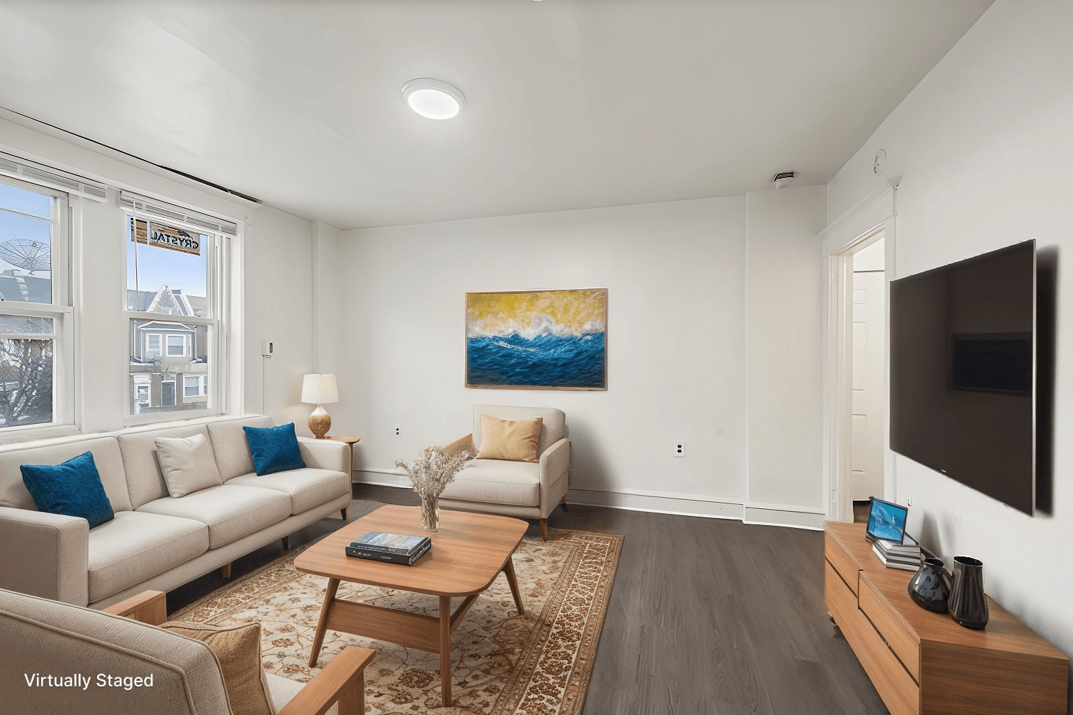 A living room with a couch, a coffee table, and a painting on the wall.