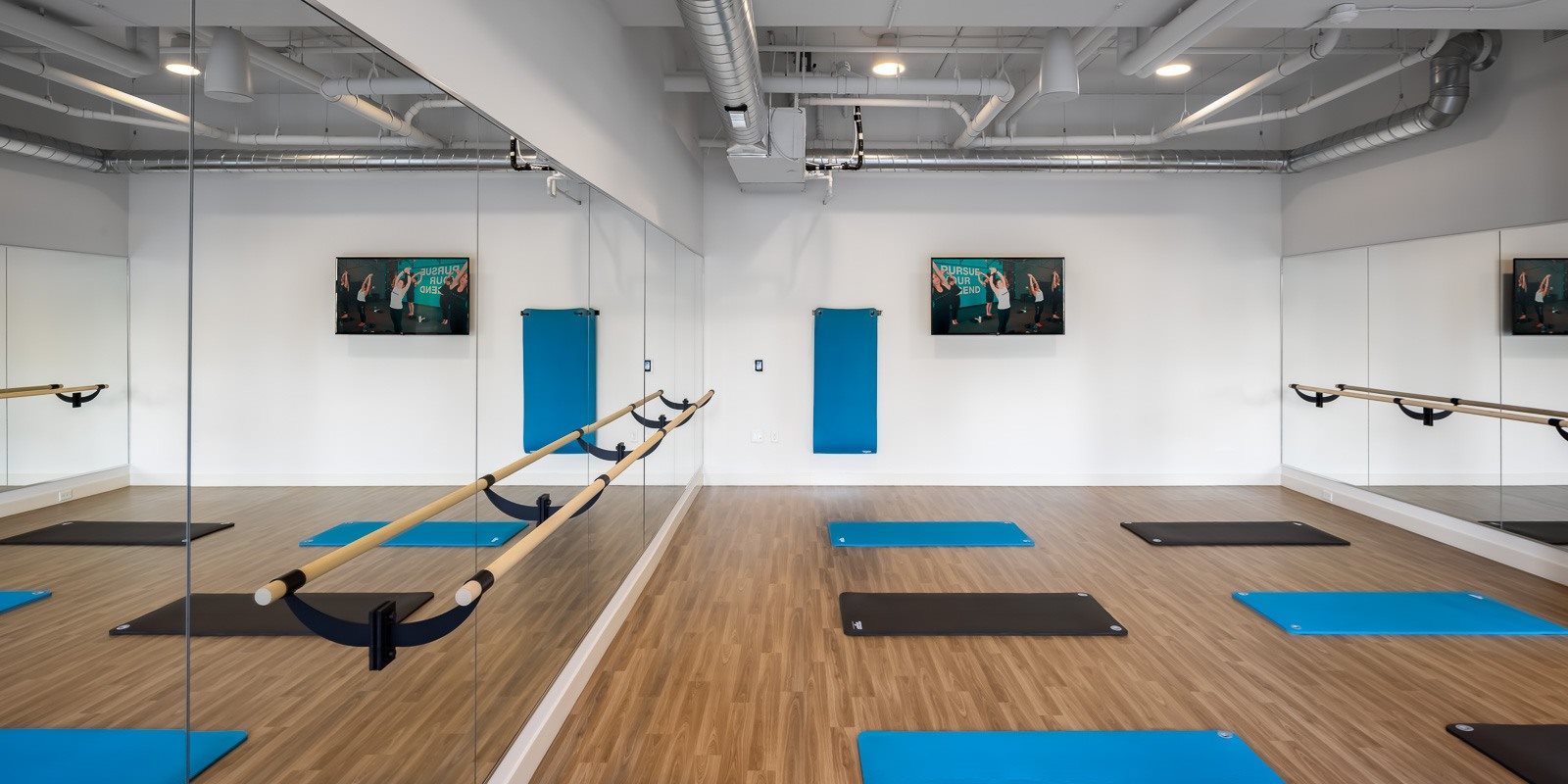 Yoga studio with Alchemy365 programming, barre and mirrors
