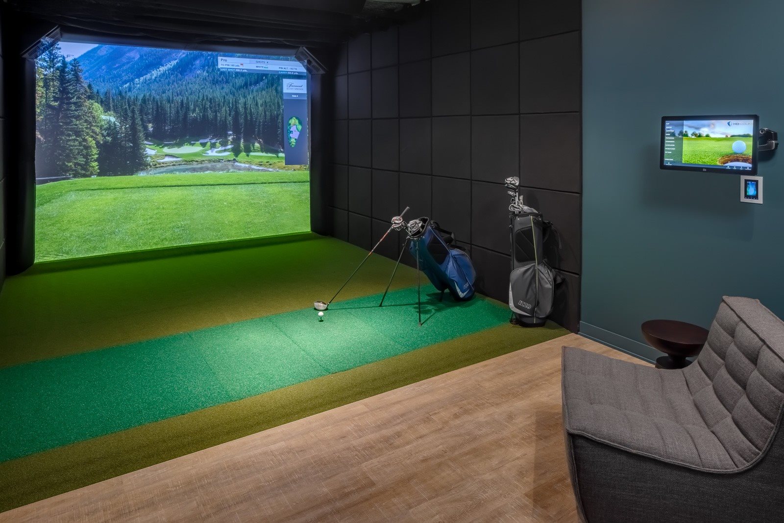 Golf simulator with clubs and pub style seating