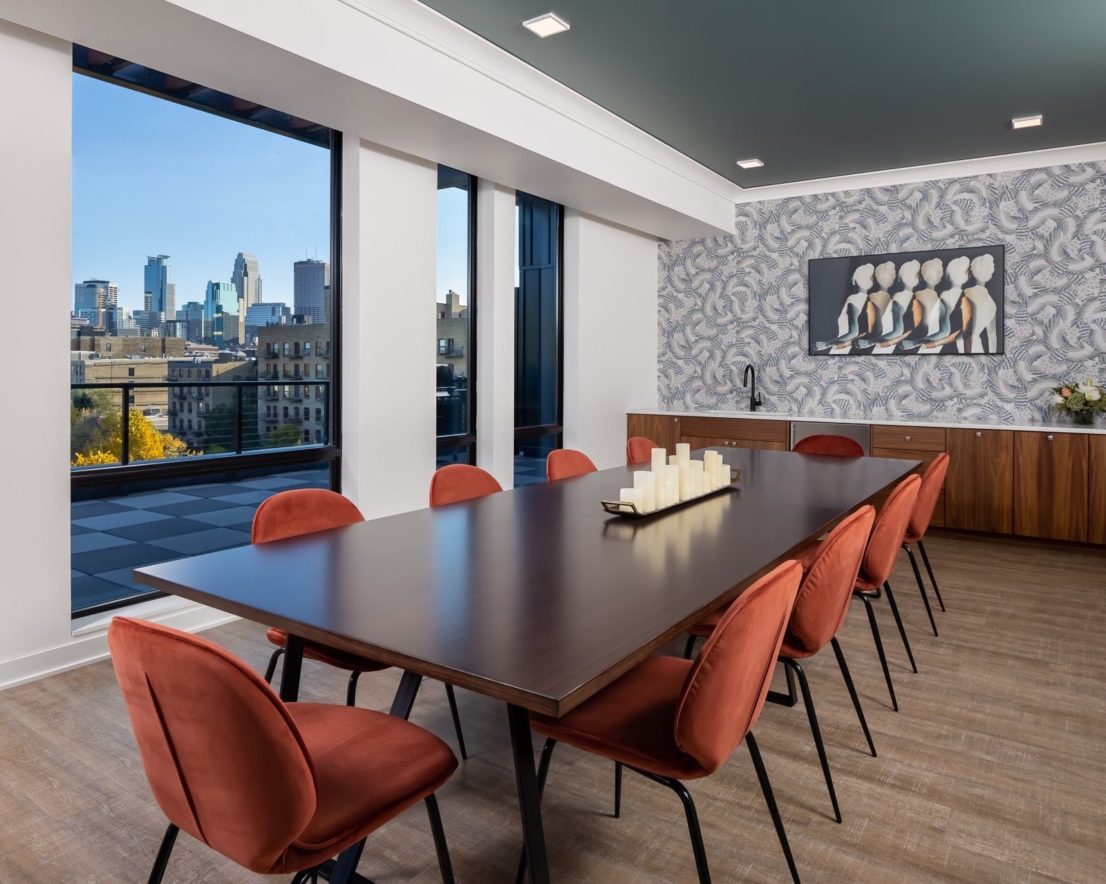 a dining room with a table and chairs and a view of the city