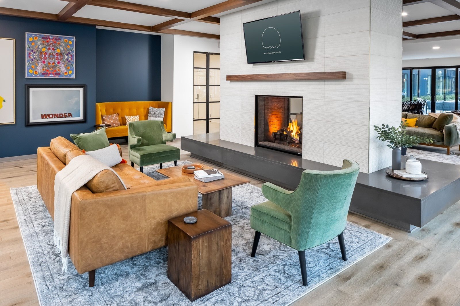 Seating in front of dual sided fireplace in club room