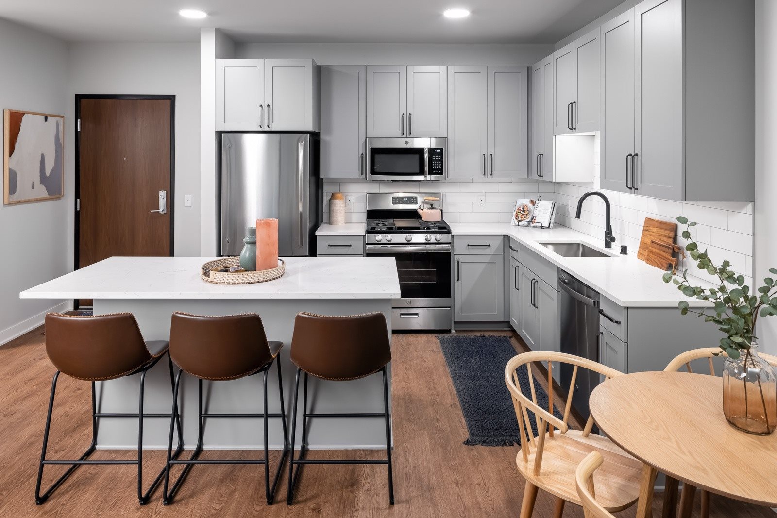 Eat-in kitchen with stainless steel appliances and backsplash
