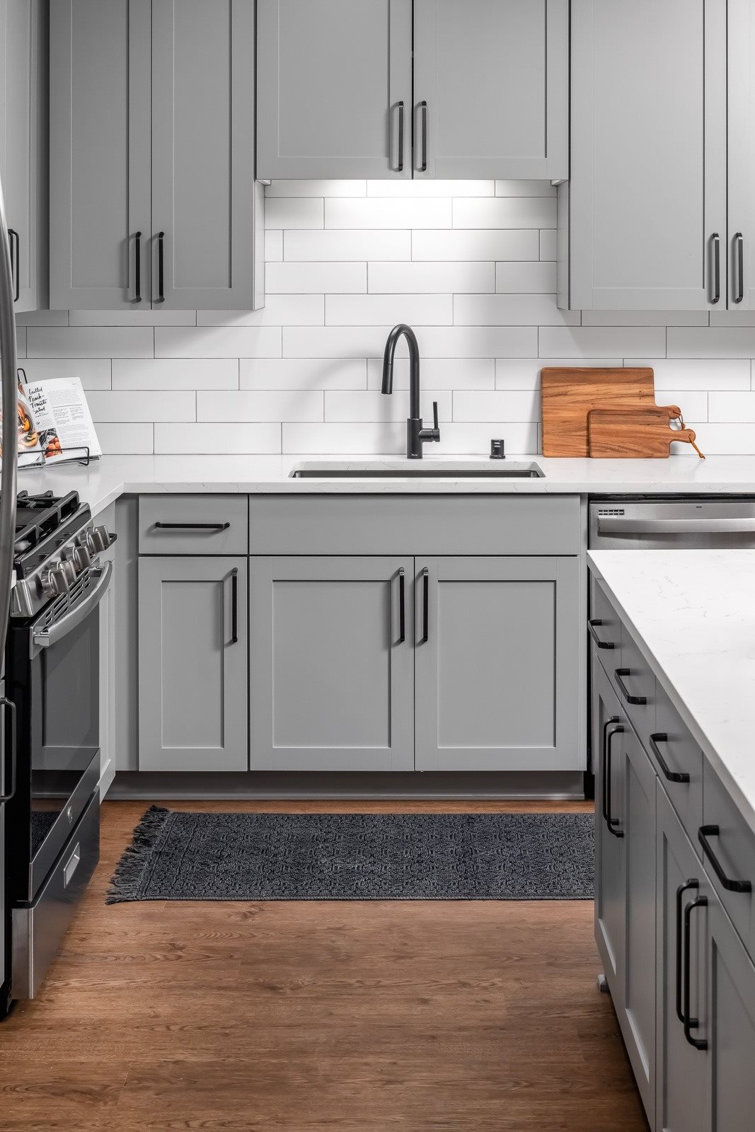 Designer finishes in kitchen with black cabinet pulls and shaker style cabinets