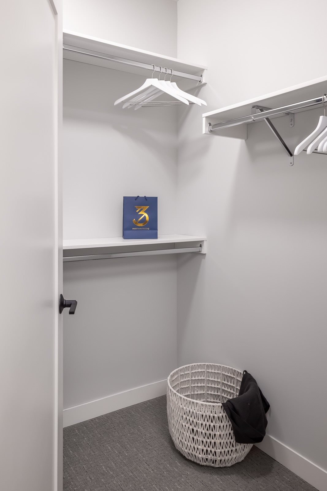 Custom closet built-ins in walk-in closet in one bedroom apartment unit