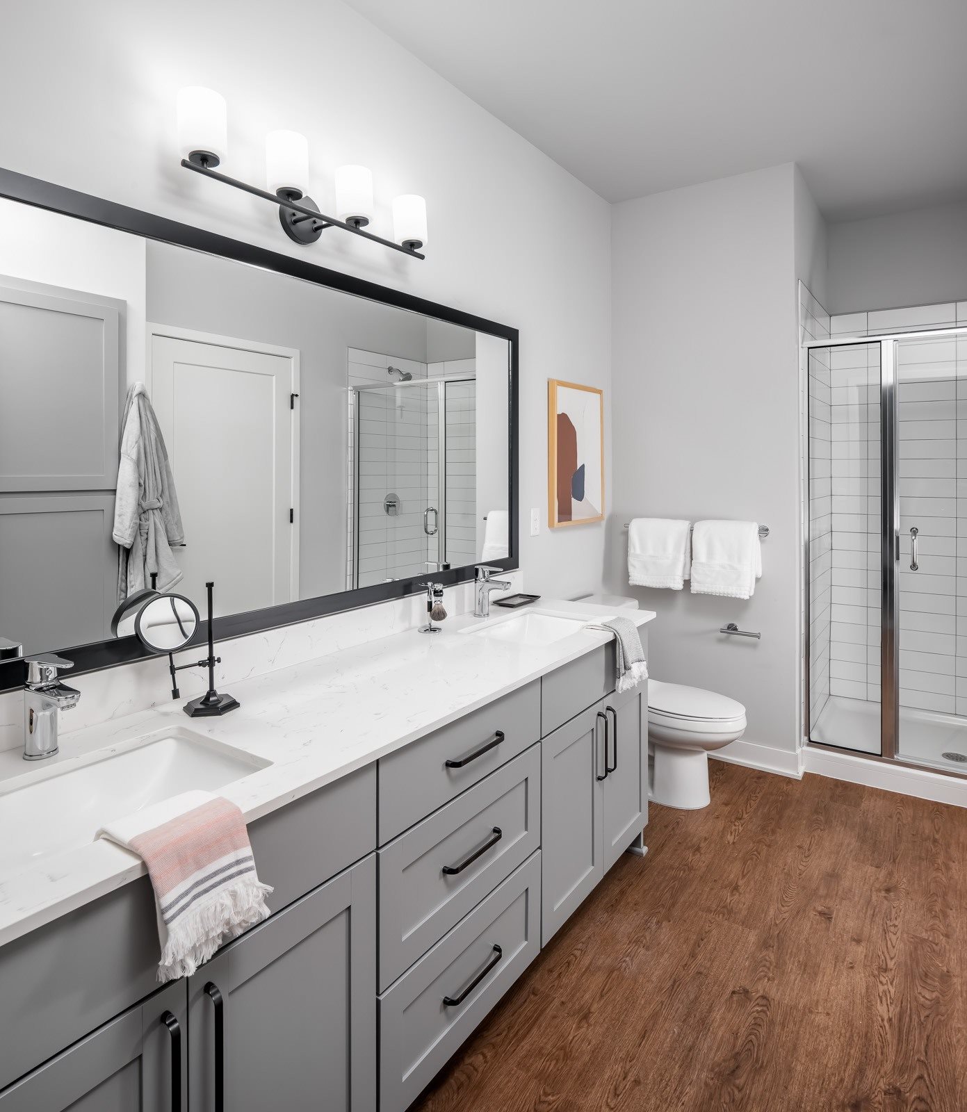 Designer bathroom with grey shaker cabinets and double vanity