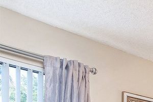 Furnished bedroom with bed, desk, dresser, ceiling fan, and two windows