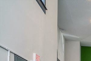 Fitness center with medicine balls, stationary bikes, weight machines, and windows