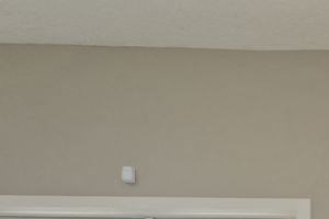 Waiting area in leasing office with cushioned chairs surrounded by over-sized windows