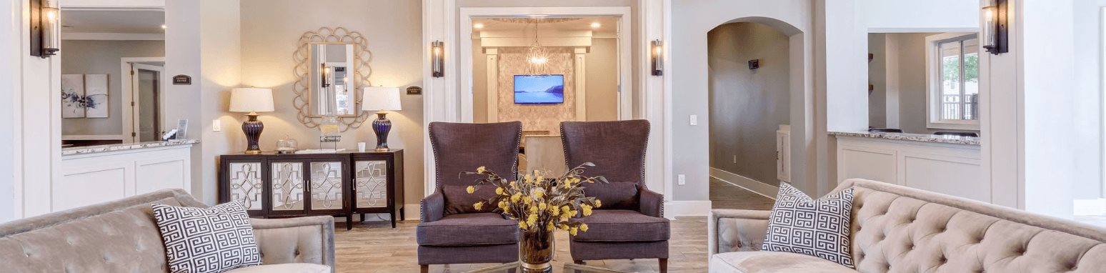 a living room with couches and a table with flowers