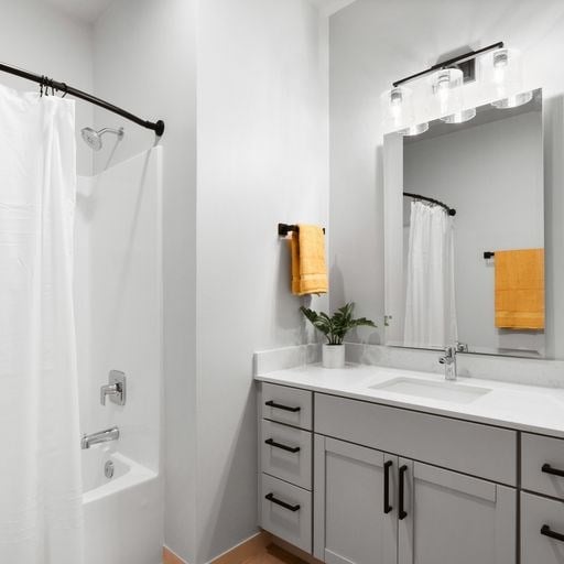 a bathroom with a white shower and a white sink