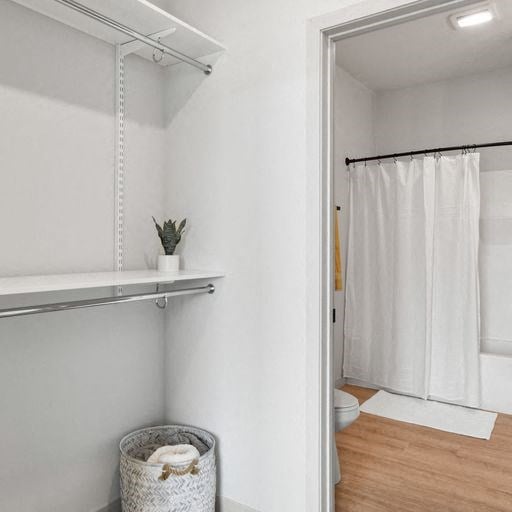 a white bathroom with a white shower curtain